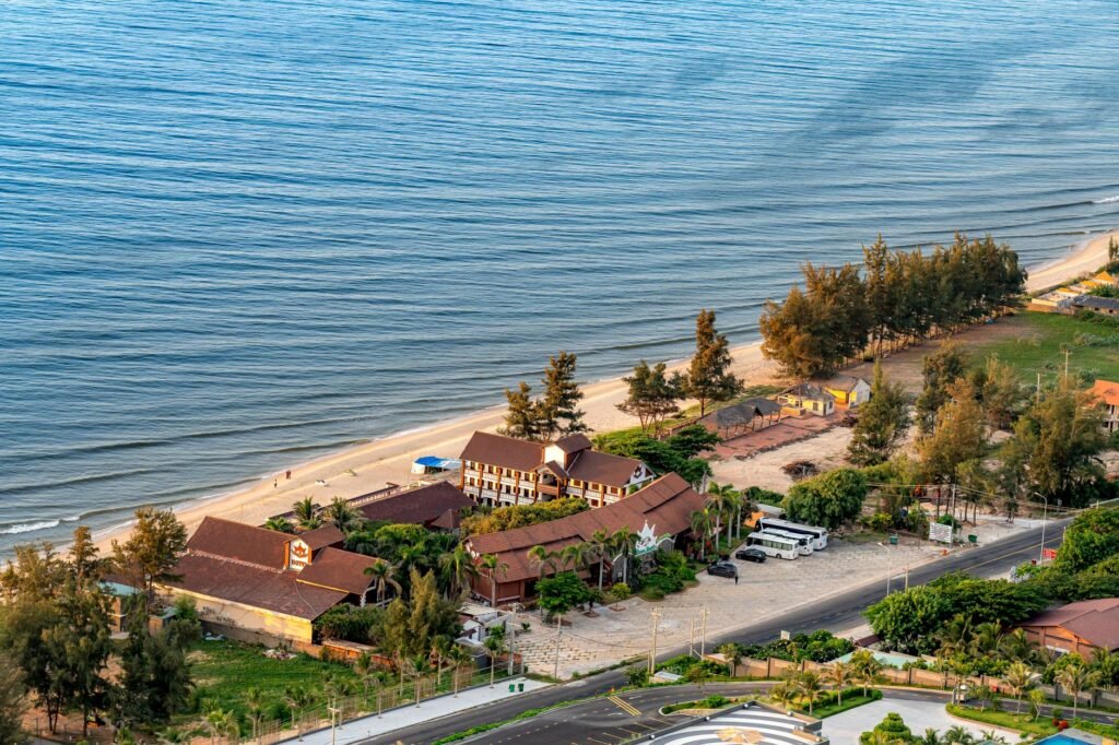 Scenic aerial view of a coastal resort by a tranquil beach, ideal for travel use.