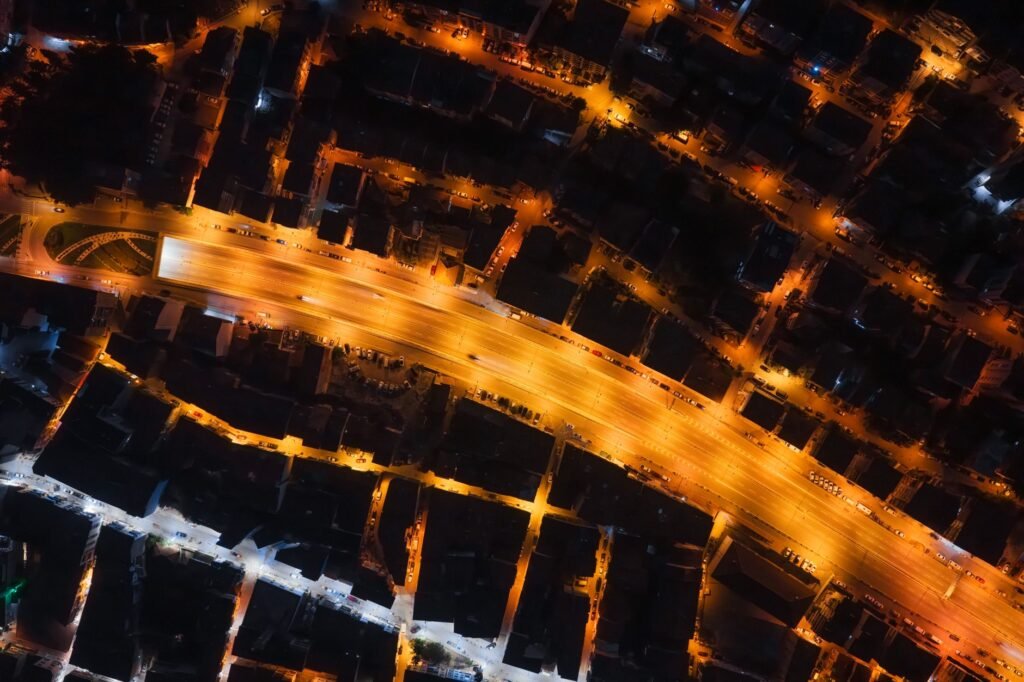 A mesmerizing aerial shot of a city with illuminated streets creating a geometric pattern at night.