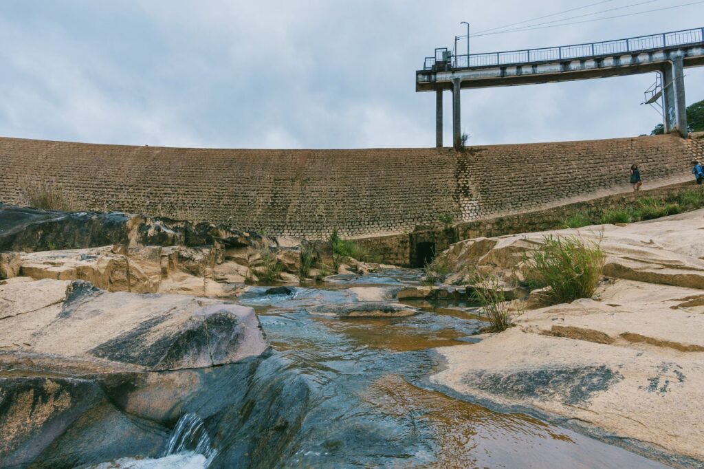 A beautiful landscape shot of a rocky river with a dam in the background, perfect for environmental themes.