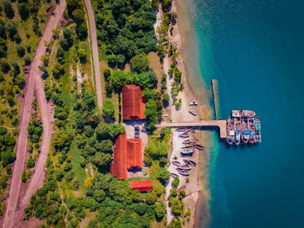 Stunning aerial shot of Bagamoyo's coastal dock, showcasing boats and lush green landscapes.