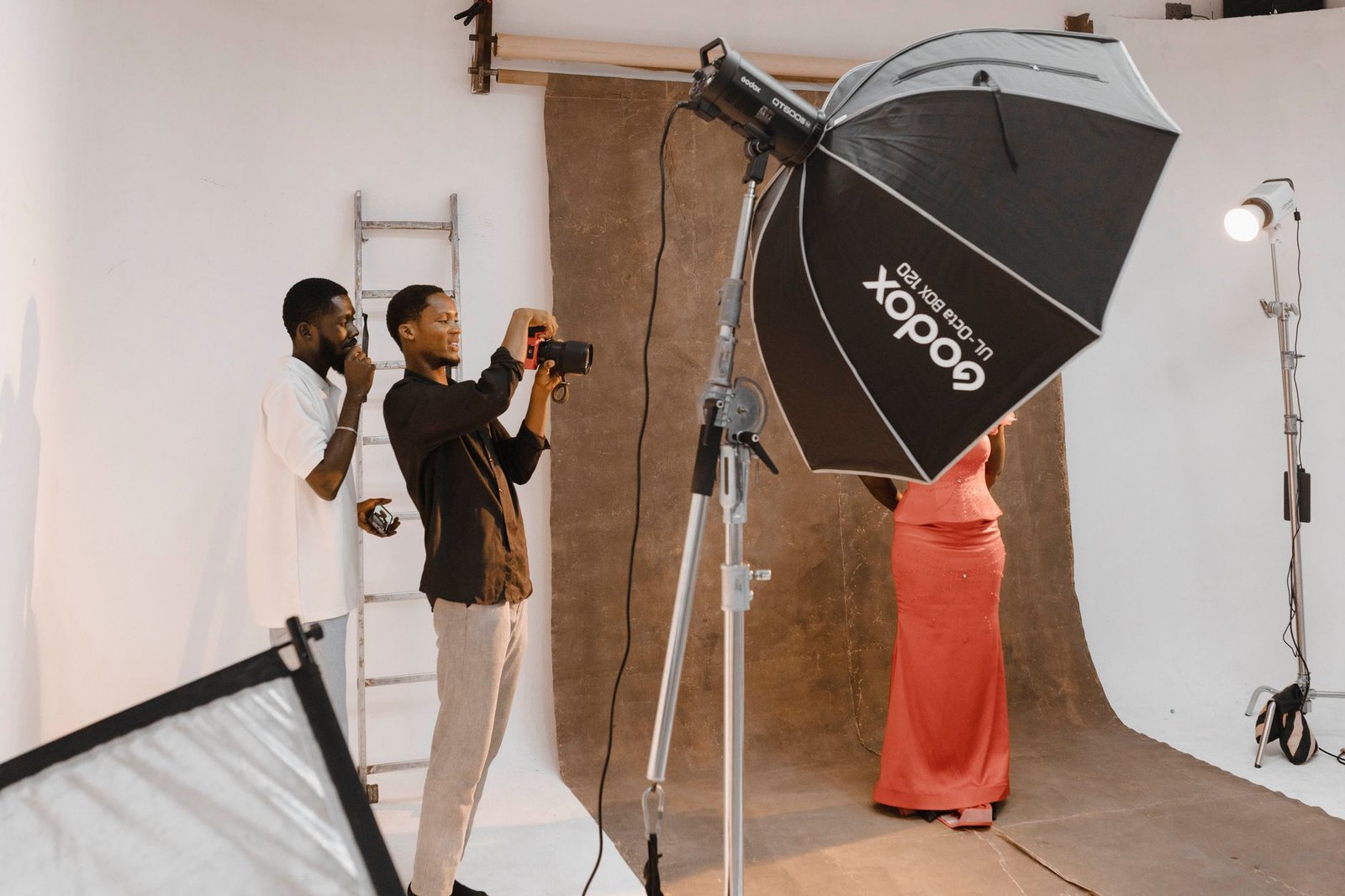 Behind-the-scenes view of a photo shoot session in a modern photography studio.