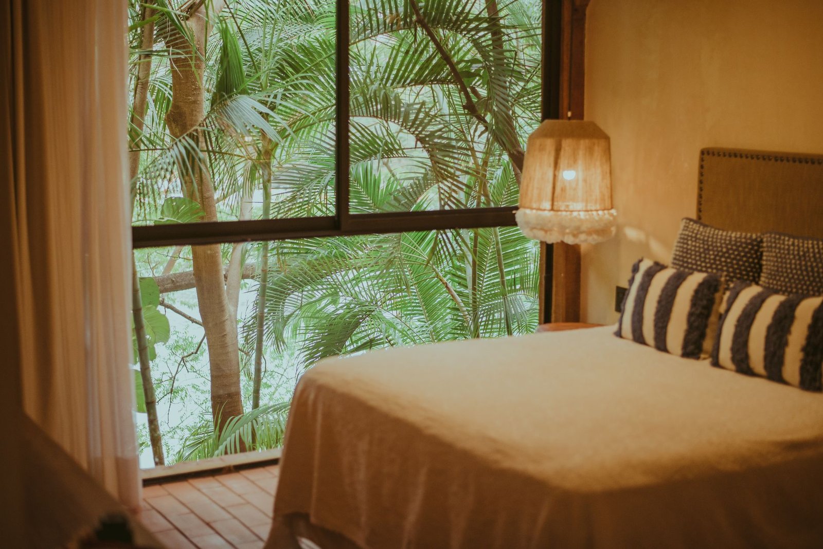 Calm hotel room with a view over green hills in a Ghanaian town, prepared for a respectful meeting
