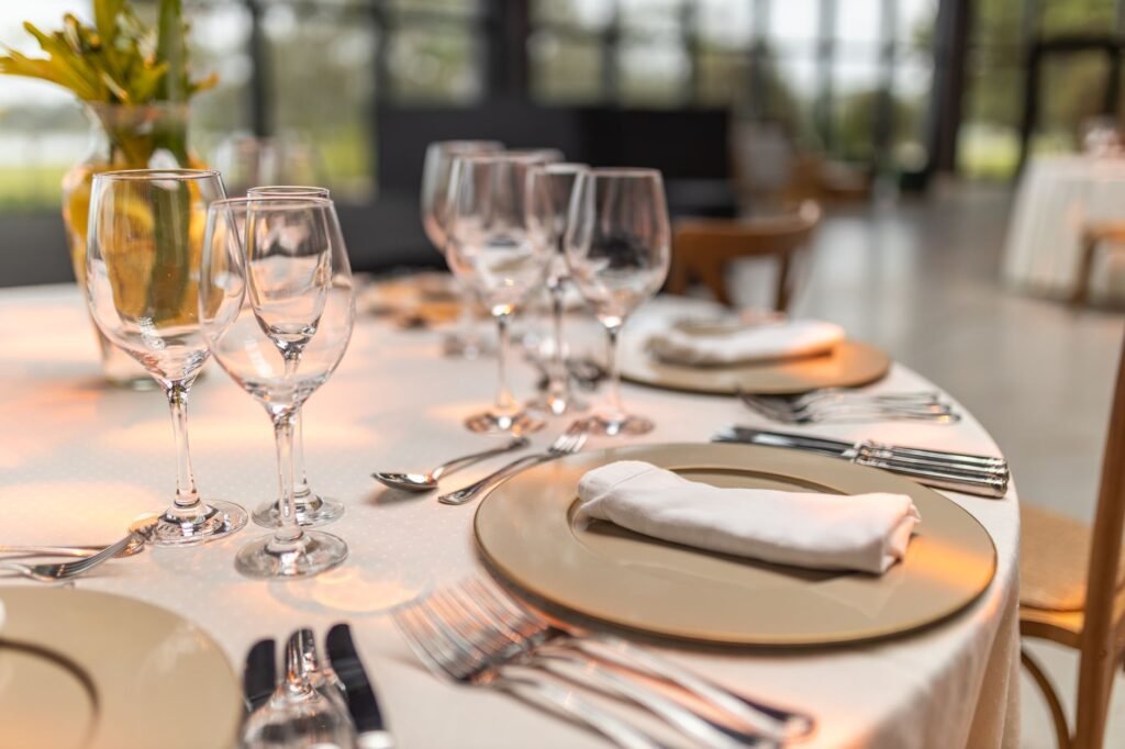 Dinner table set for two in a restaurant with warm lighting
