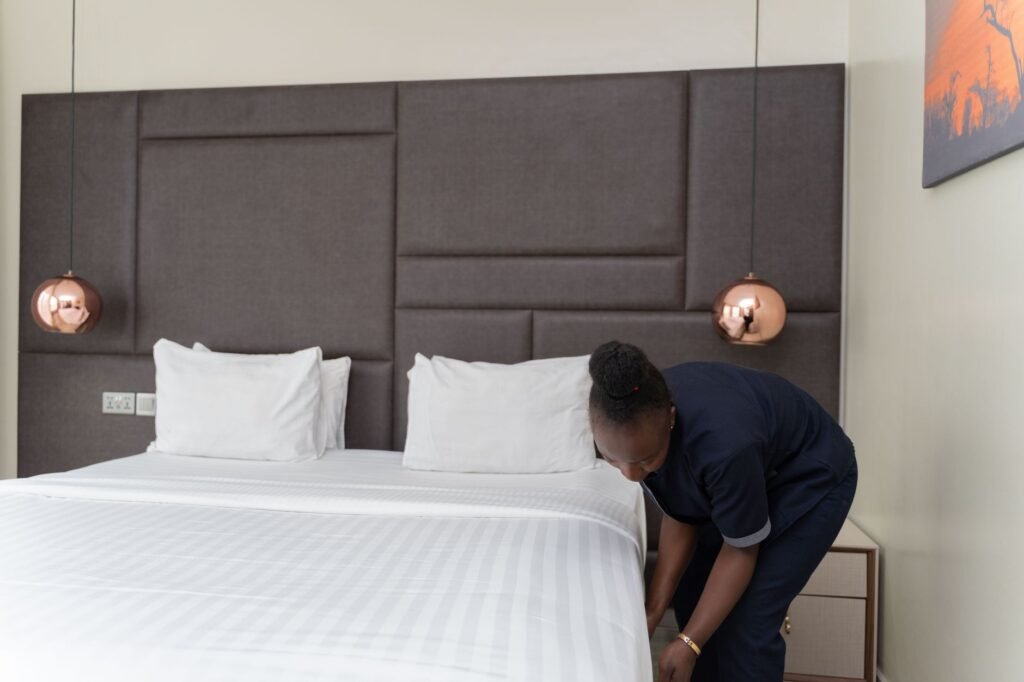 Simple, tidy guest house room with natural daylight in a Ghanaian town