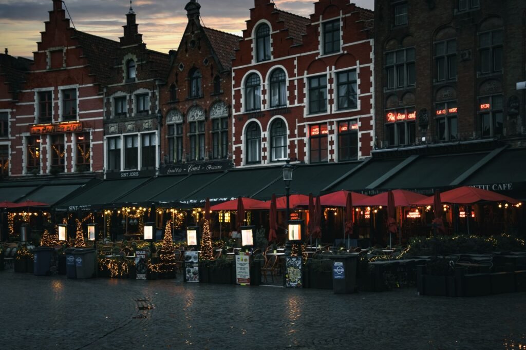 Outdoor seating area beside a main road in the evening