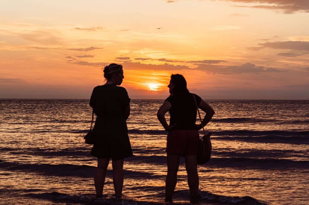 Two people in relaxed conversation, one listening attentively