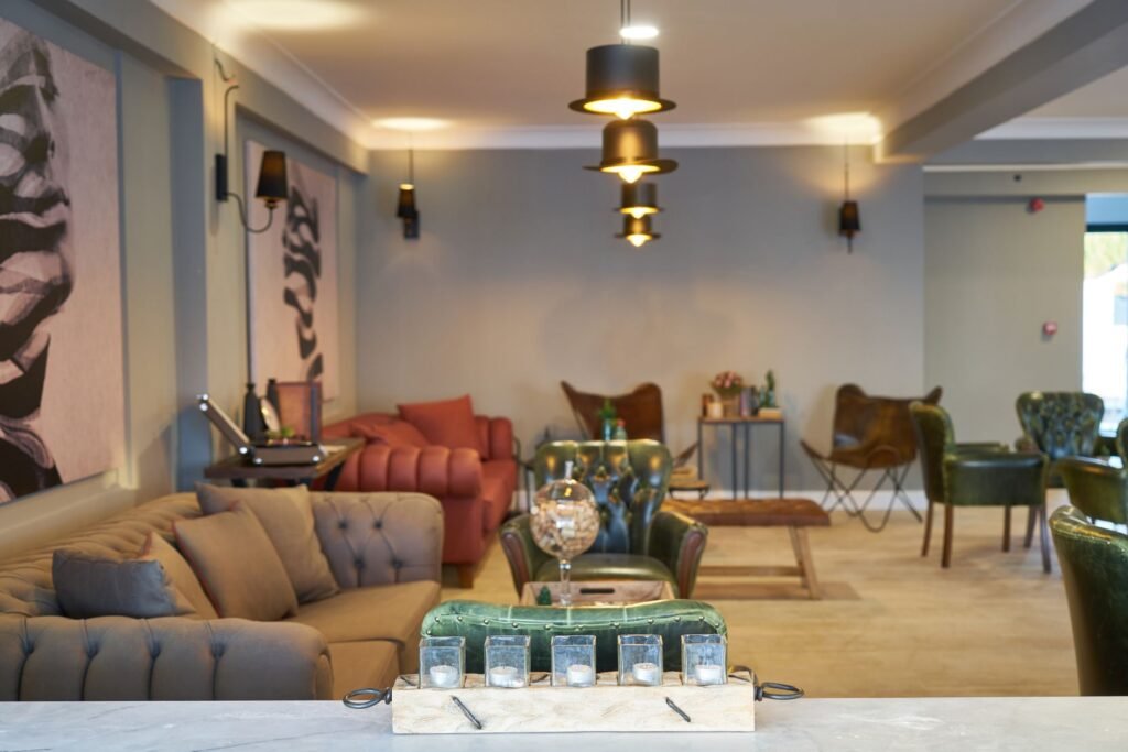 Stylish Kumasi lounge interior with low sofas and soft pendant lighting at night