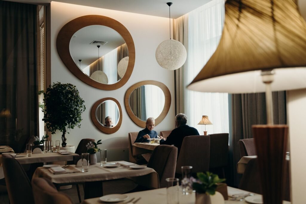 Two people in quiet conversation at a restaurant table