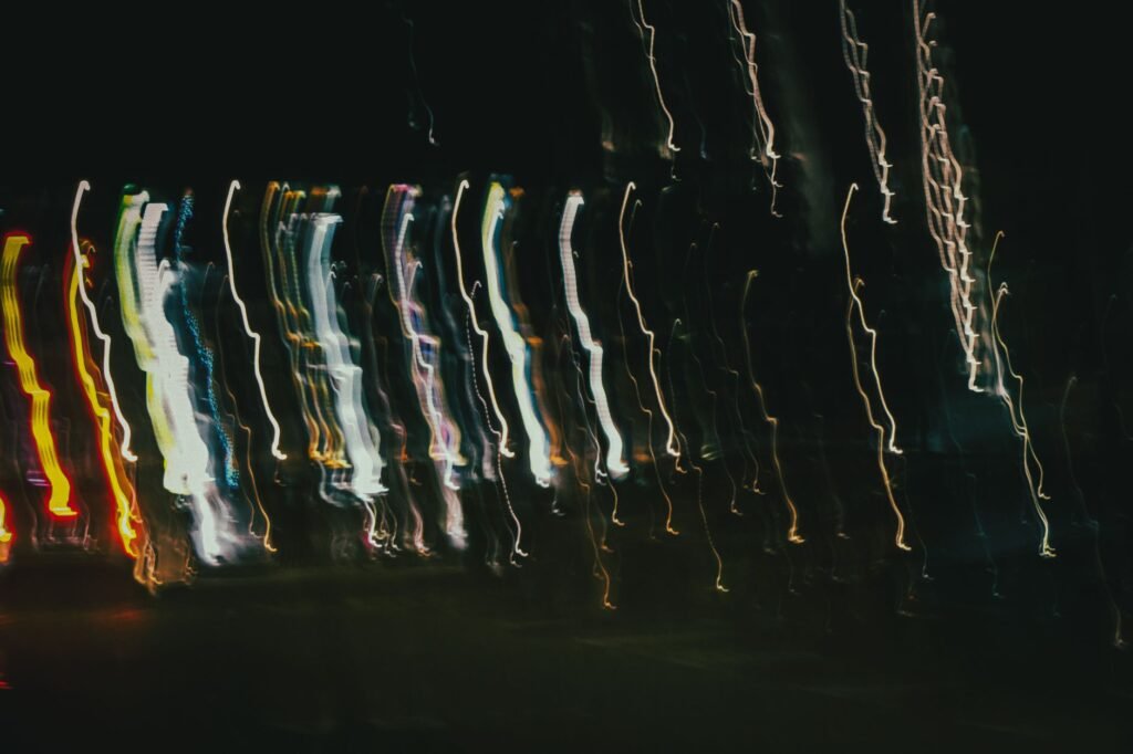 Blurred motion of city streetlights in Singapore creates an abstract, dynamic night scene.