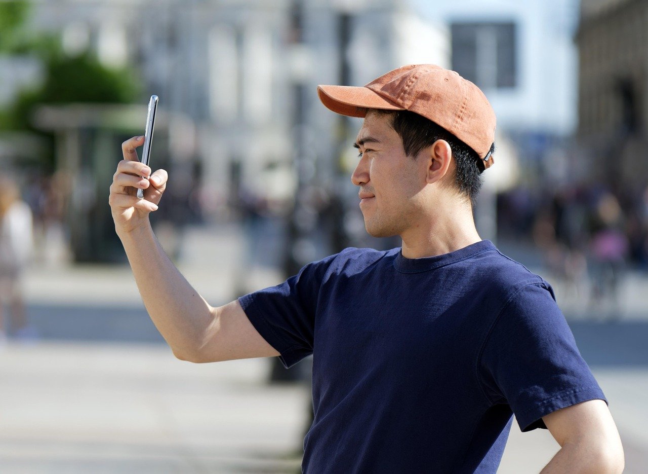 man, tourist, casual, young, smartphone, outdoors, urban, street, photography, lifestyle