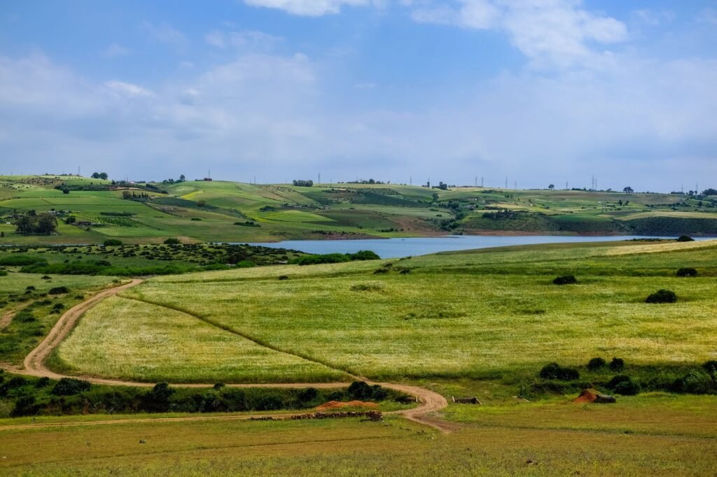 A beautiful landscape with rolling green hills near the water on a clear day in Rabat, Morocco.