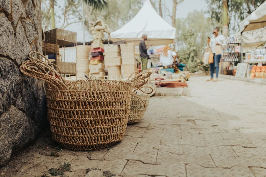 Rustic handmade baskets displayed at a vibrant street market in Abuja, Nigeria.