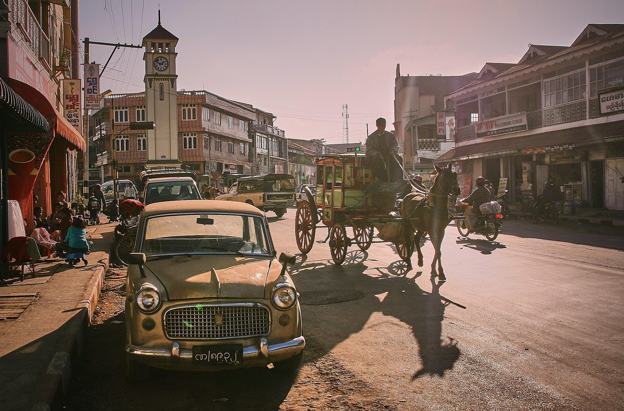 street scene, automobile, myanmar, horse-drawn carriage, coach, road, antique car, historical, retro, lighting mood, street s