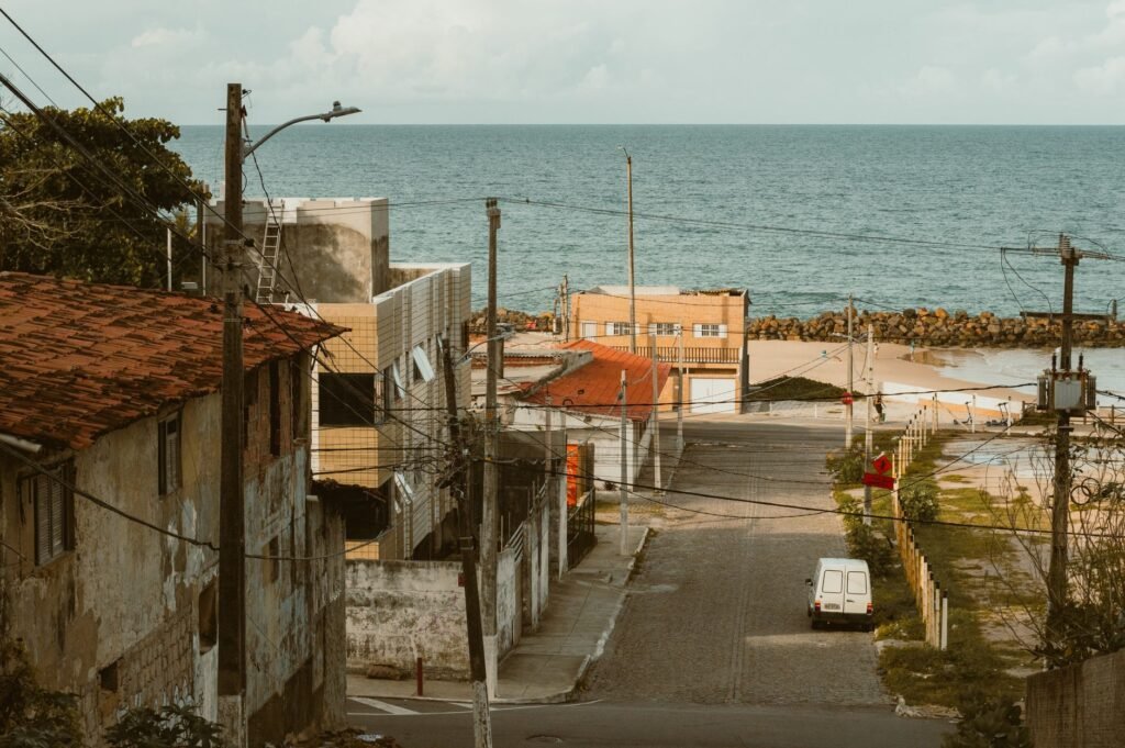 Urban street in Natal, Brazil leading to the ocean, showcasing coastal architecture and vibrant seaside ambiance.