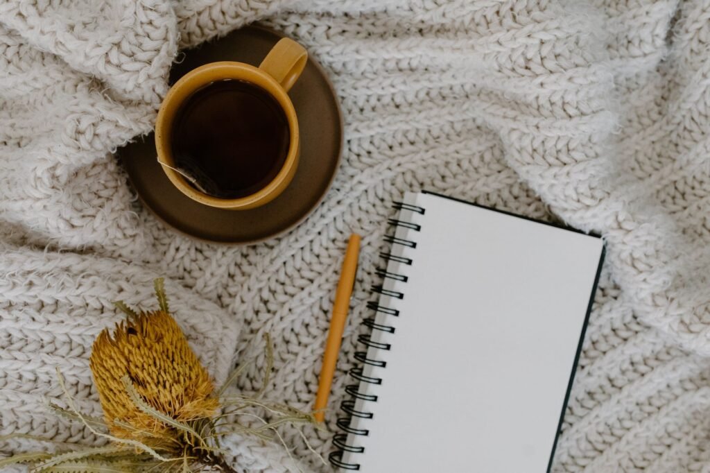 Notebook and tea on a table in soft morning light