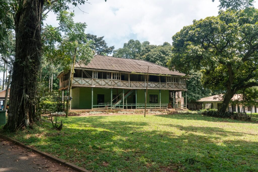 Modest guesthouse exterior in a Ghanaian town in warm afternoon light