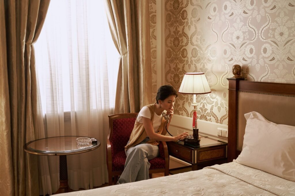 Smartphone face-down on a bedside table in a softly lit hotel room
