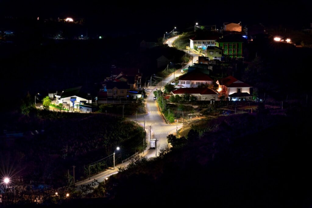 Softly lit street corner in a small Ghanaian town at night