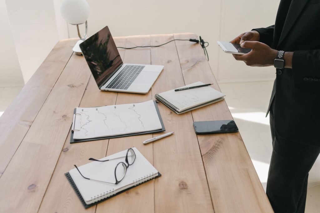 Phone and notebook on a table, suggesting planning a first message