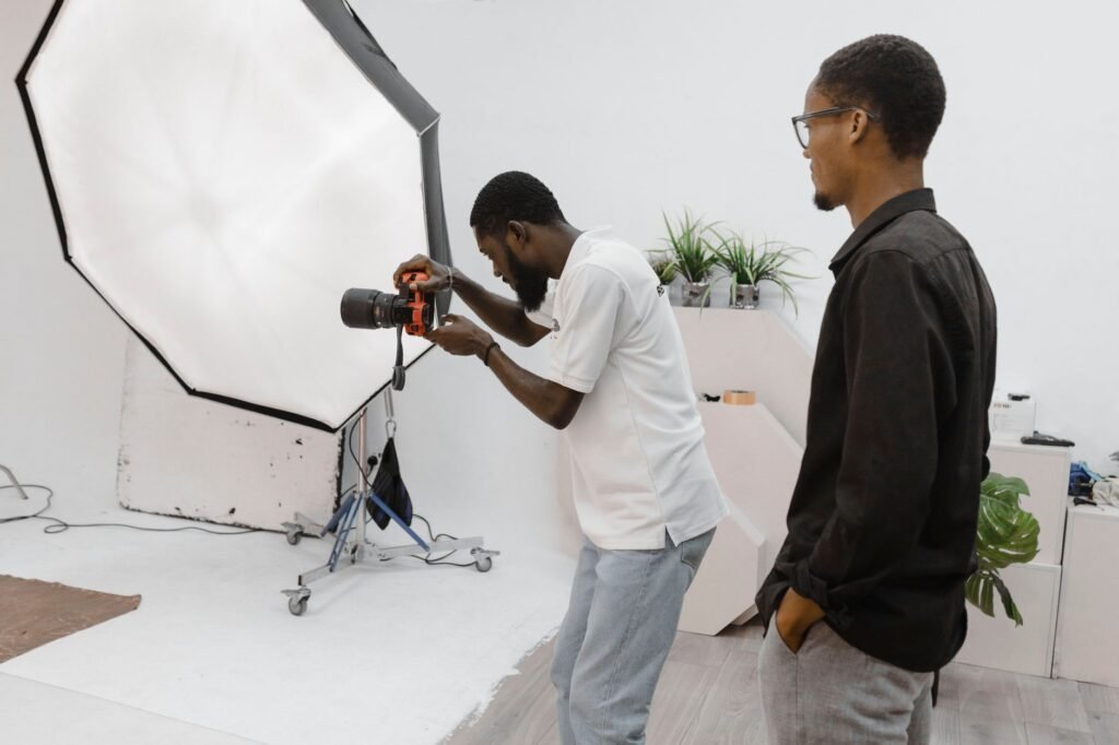 Photographer in action during a studio session in Accra, Ghana, capturing professional portraits.