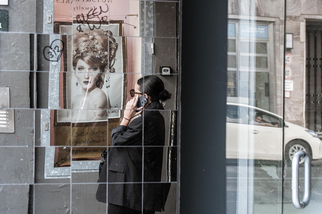 city, woman, phone call, smartphone, poster, mirror image, reflection, street scene