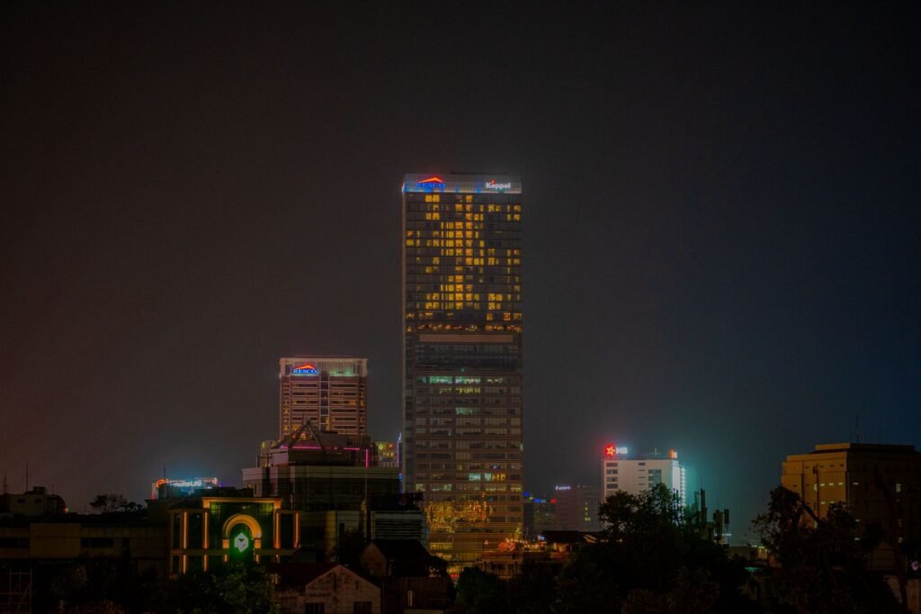 Illuminated skyscrapers in the night skyline of Ho Chi Minh City, showcasing urban architecture.