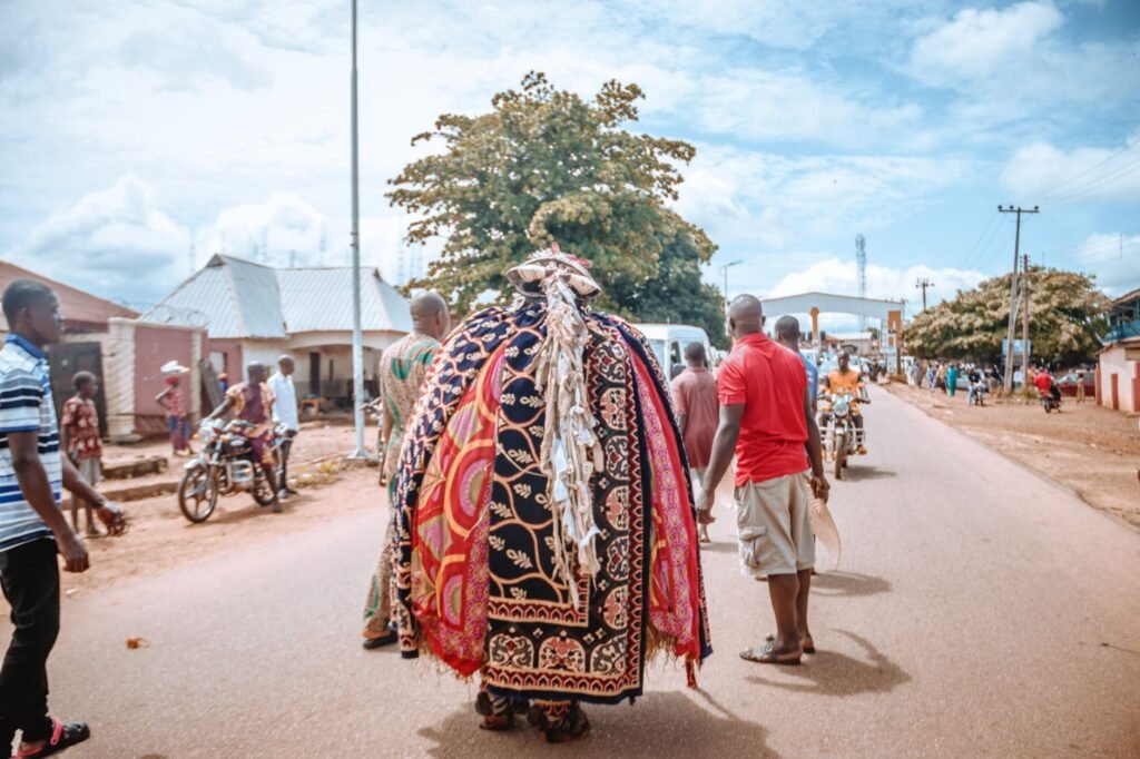 A vibrant traditional festival procession on city streets showcasing colorful attire and cultural celebration.