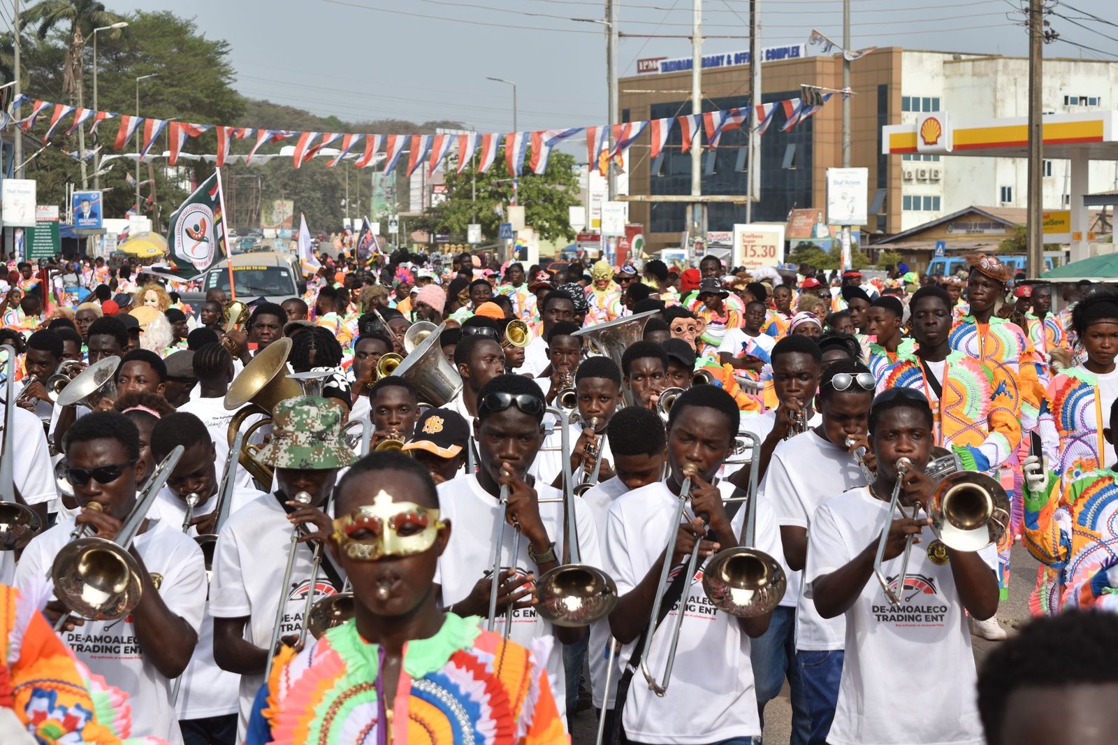 Vibrant street parade featuring brass band musicians in colorful attire, capturing festive spirit.