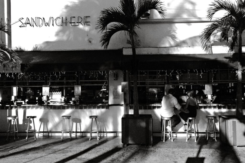 Couple enjoys a meal at a chic outdoor café on Miami Beach, Florida.