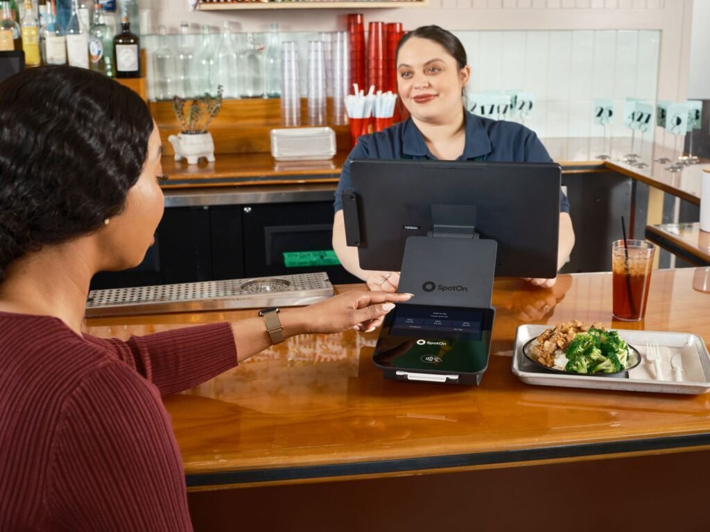 A small cash tip left beside a glass on a bar counter