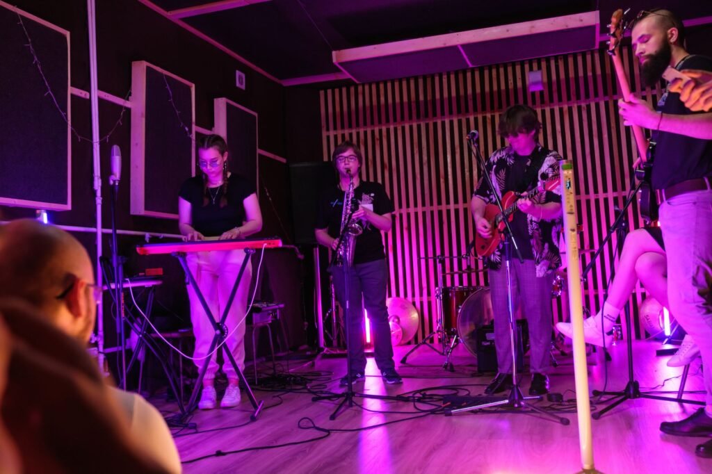 Small live music venue with warm stage lighting, the second stop of the evening
