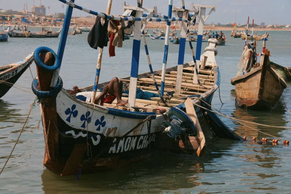 Colorful fishing boats docked at the harbor in Accra, capturing local maritime culture.