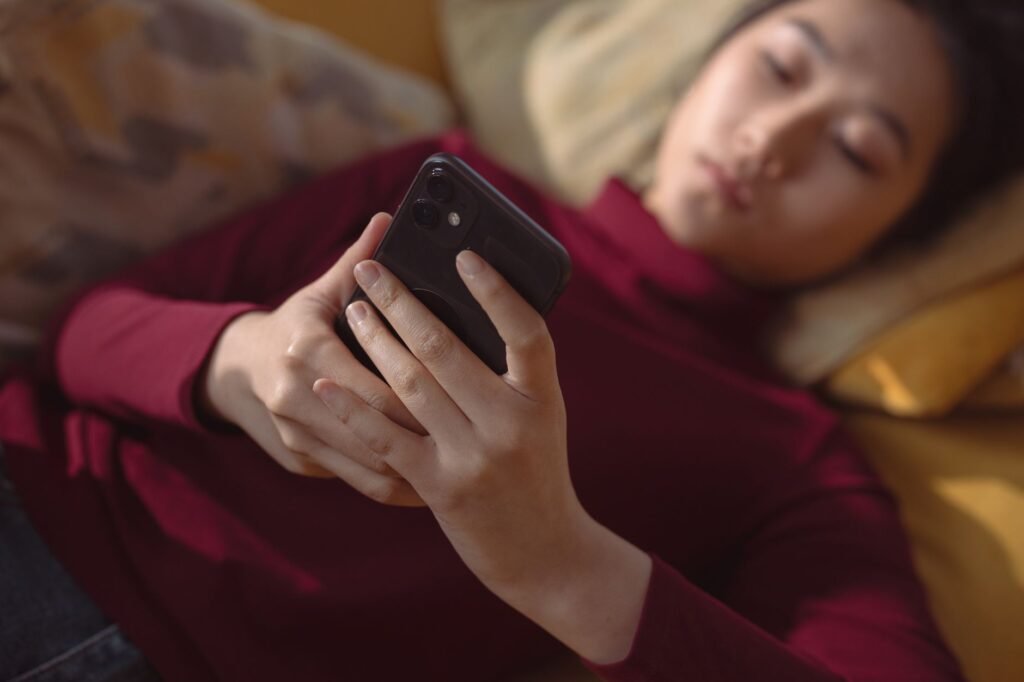 Person browsing an online directory on a smartphone indoors