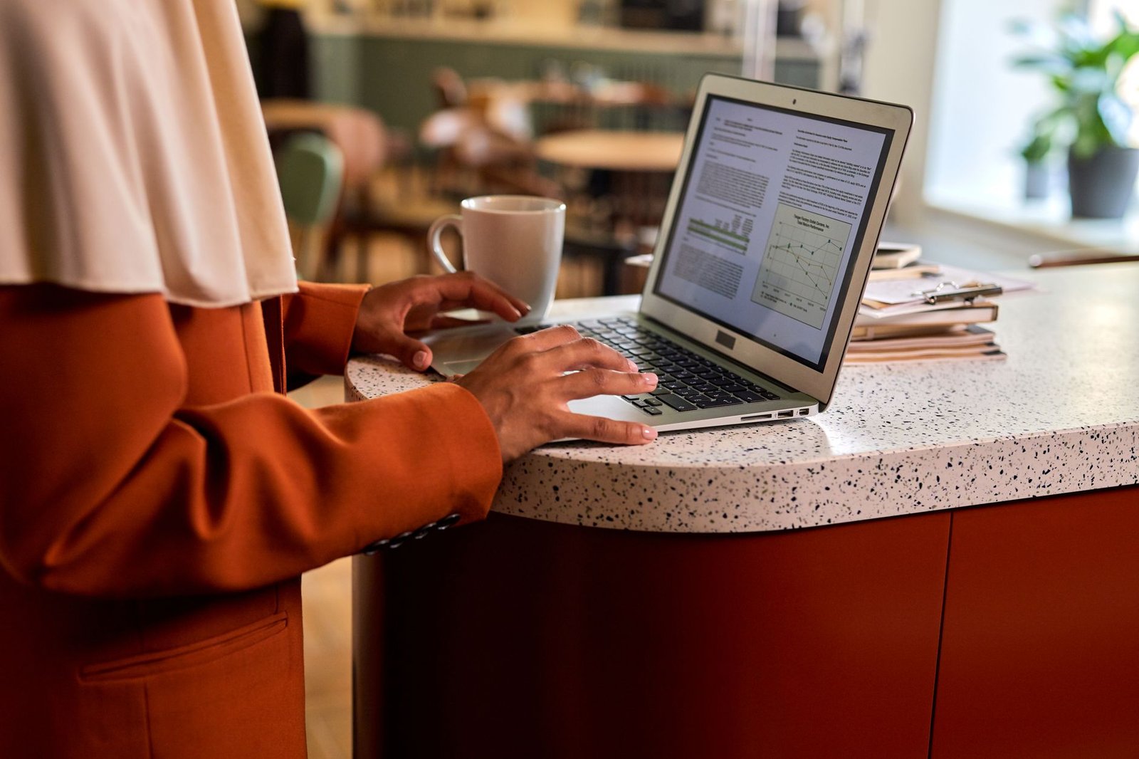 Person reviewing an online directory on a laptop at a desk in natural daylight