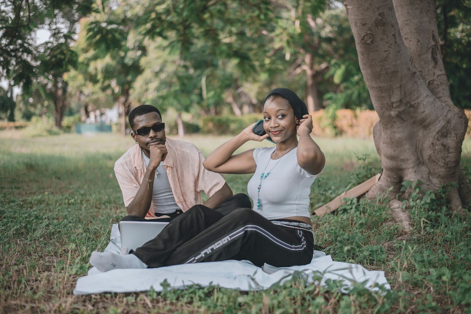 Young couple enjoying a relaxing day outdoors in a park during summer.