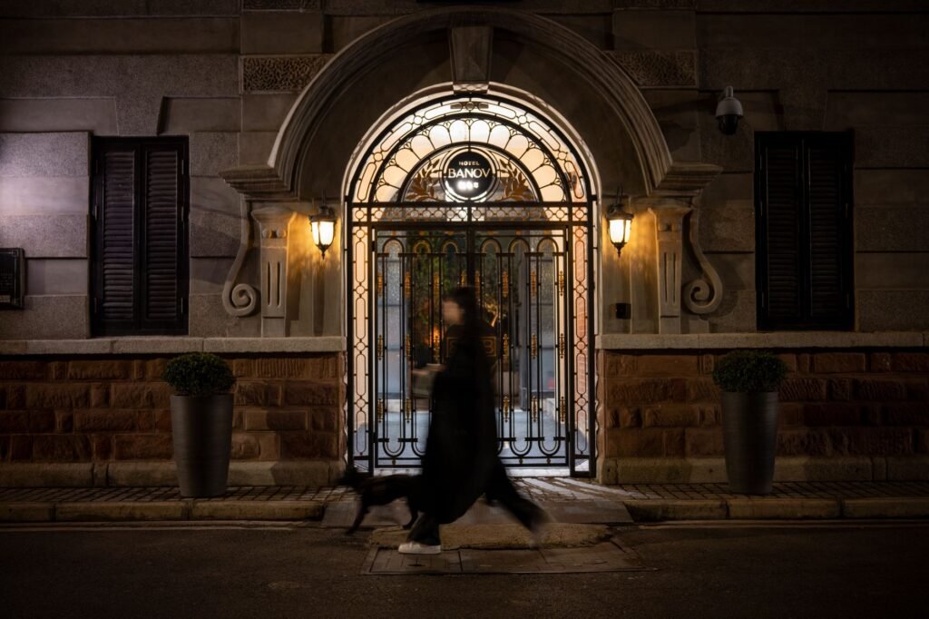 Quiet hotel side entrance with warm evening lighting