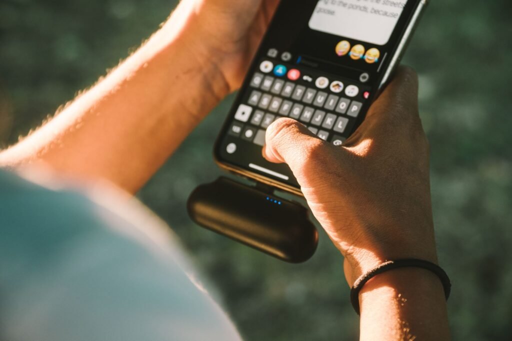 Smartphone, power bank and torch on a table ready for an evening out