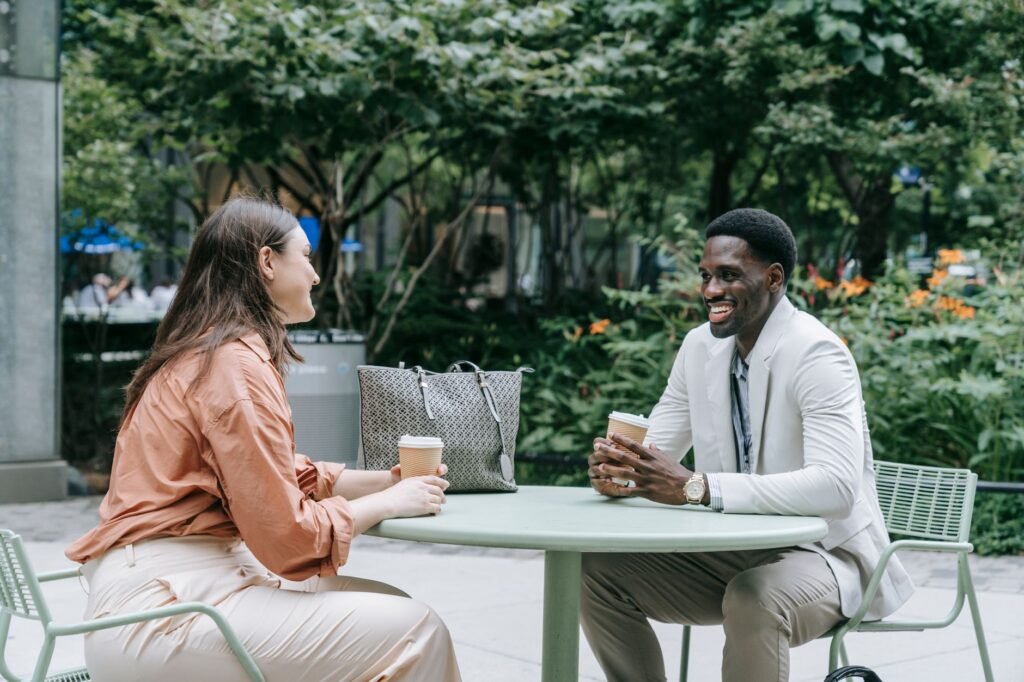 Two adults meeting in a public cafe while discussing arrangements