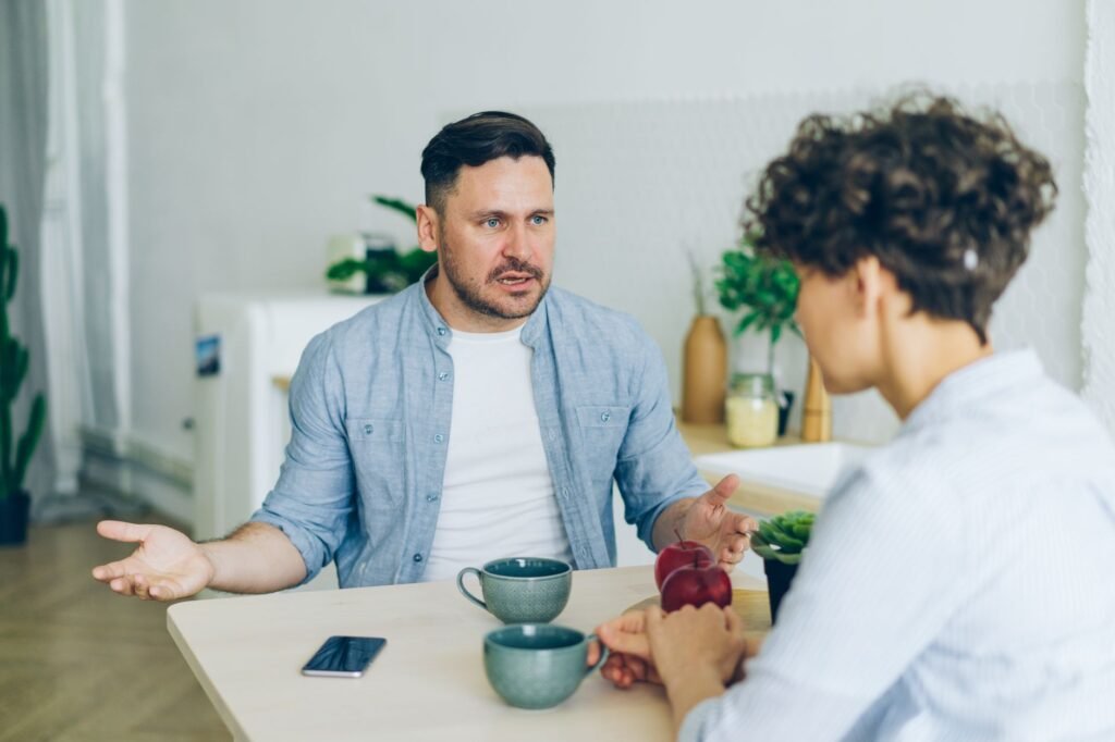 Two adults having a calm conversation indoors