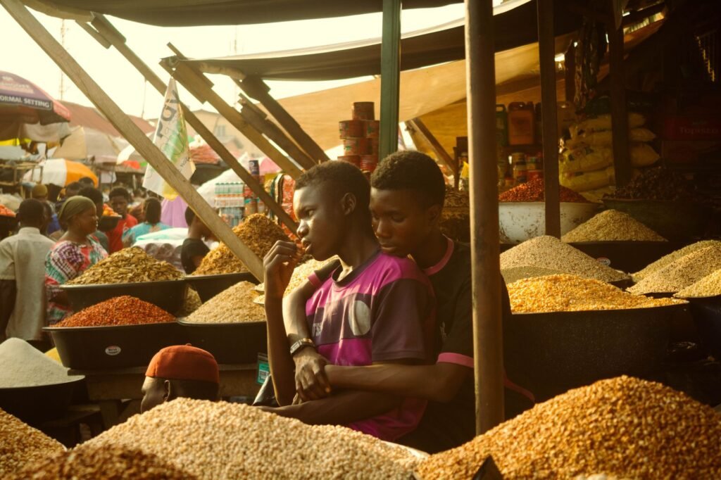 Busy open-air market in a West African town during the morning trading hours