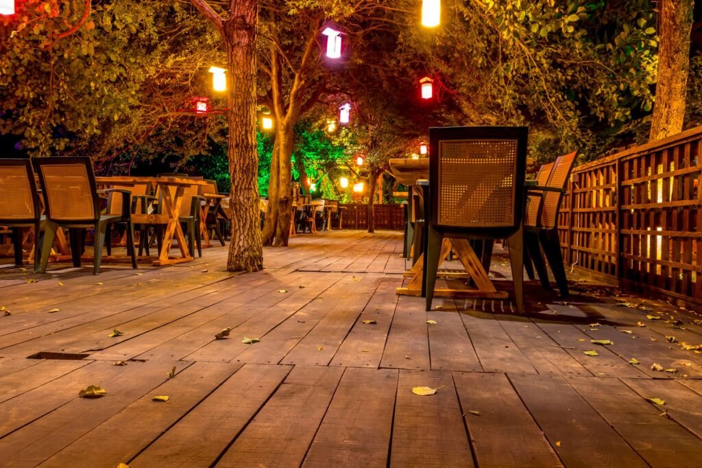 Small restaurant terrace in Ghana in the early evening with warm lighting and seated guests