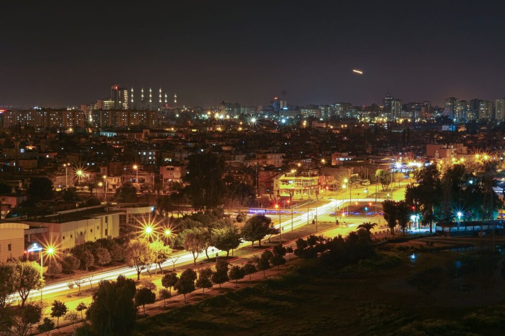 Stunning aerial view of a city at night with bright streetlights and illuminated skyline.